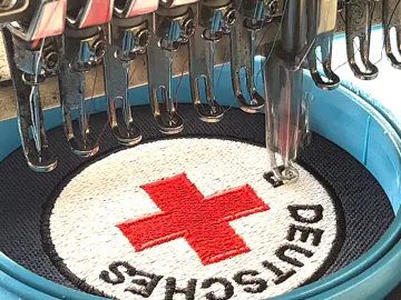 Advertising and promotional clothing with embroidery